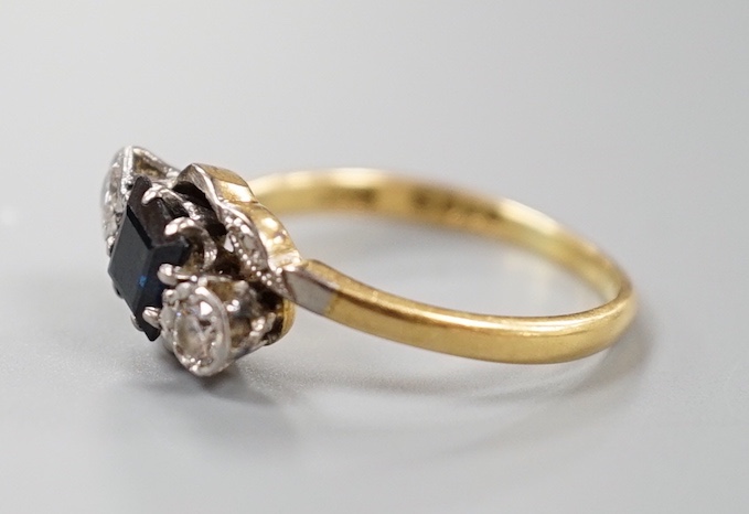 A 1960's 18ct gold, sapphire and diamond set three stone crossover ring, size M, gross weight 3 grams.